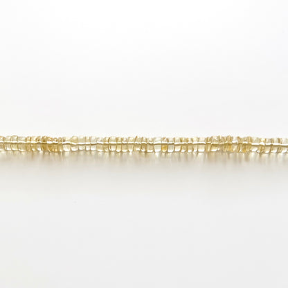 Close up strand of citrine beaded gemstone necklace with golden yellow orange smooth rondelle beads that are translucent in color
