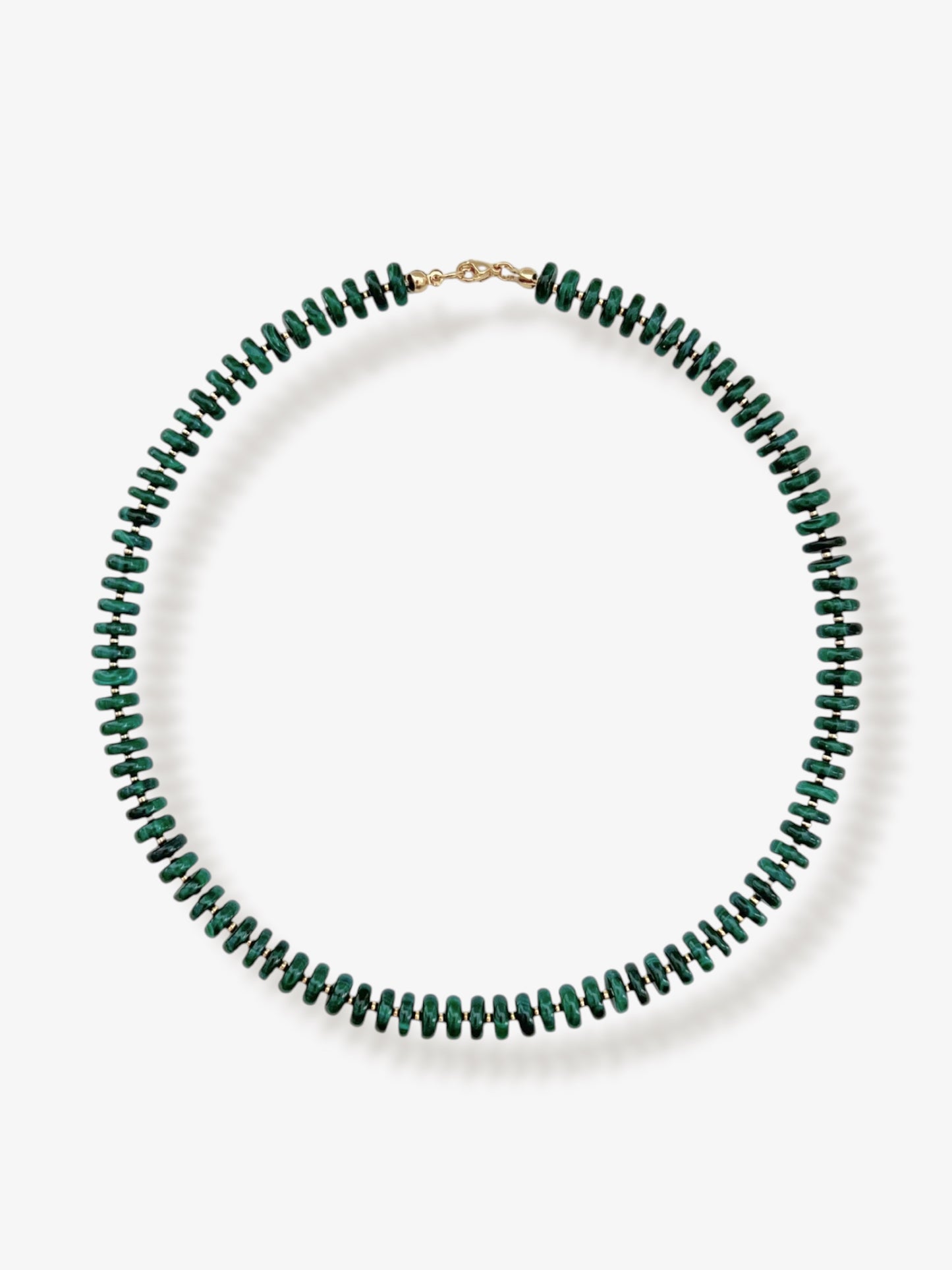 Malachite beaded gemstone necklace with chunky dark green smooth disc rondelle beads and 14k gold filled beads and clasp with minimalist design on a neutral background