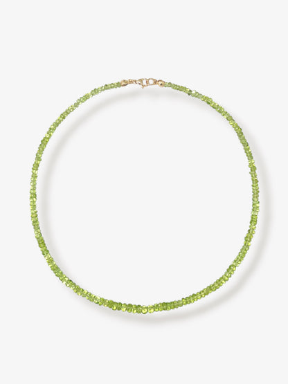 Peridot beaded gemstone necklace with green smooth rondelle beads and 14k solid gold or gold filled clasp with a minimalist design on a neutral background