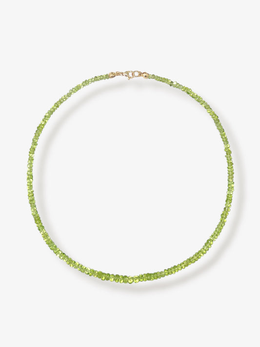 Peridot beaded gemstone necklace with green smooth rondelle beads and 14k solid gold or gold filled clasp with a minimalist design on a neutral background