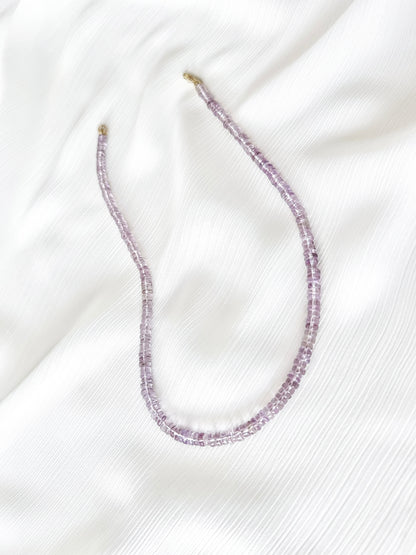 Pink Amethyst beaded gemstone necklace with translucent light purple smooth rondelle beads and 14k gold filled or solid gold clasp with a minimalist design on soft white fabric background
