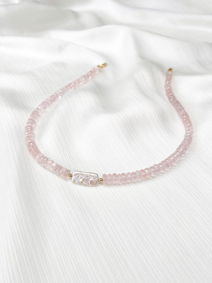 Rose Quartz beaded gemstone necklace with freshwater keshi pearl and pink faceted rondelle beads and 14k gold filled or solid gold clasp with minimalist design on a soft white fabric background